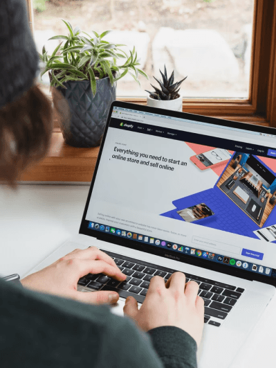 person using the shopify app on their computer